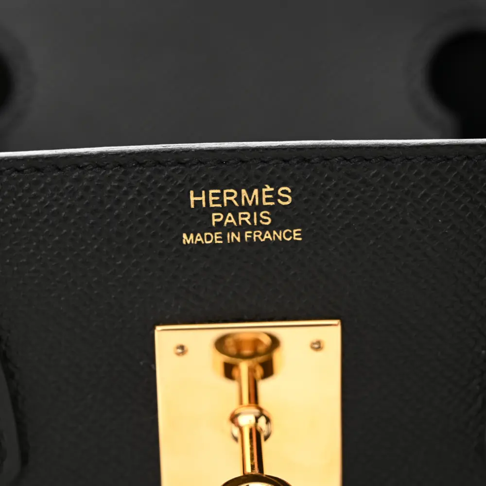 Close-up of the Herme$ Birkin 30 lock, gold hardware, and signature sangles straps