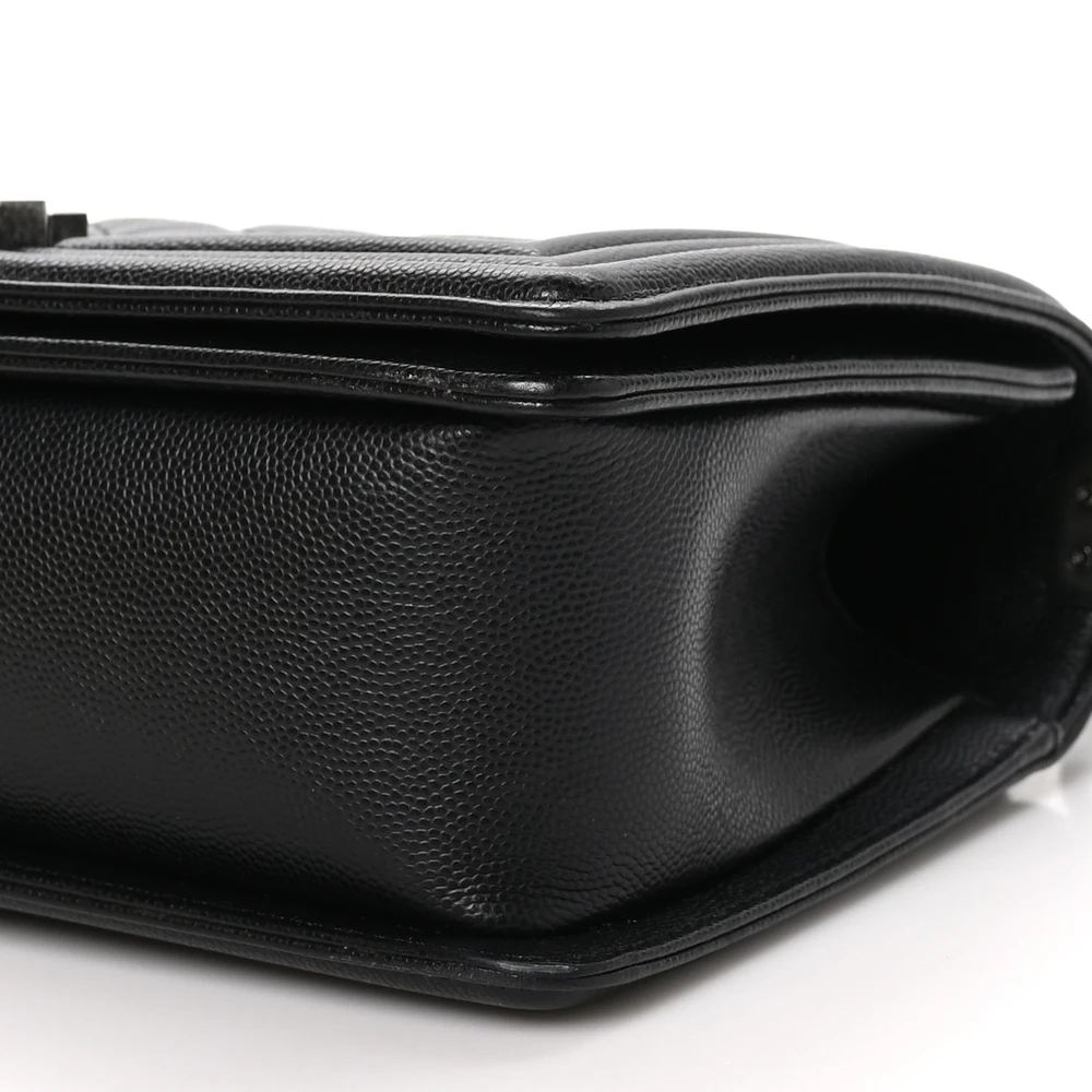 Bottom view of the black caviar leather Medium Boy Flap showing the structured leather base