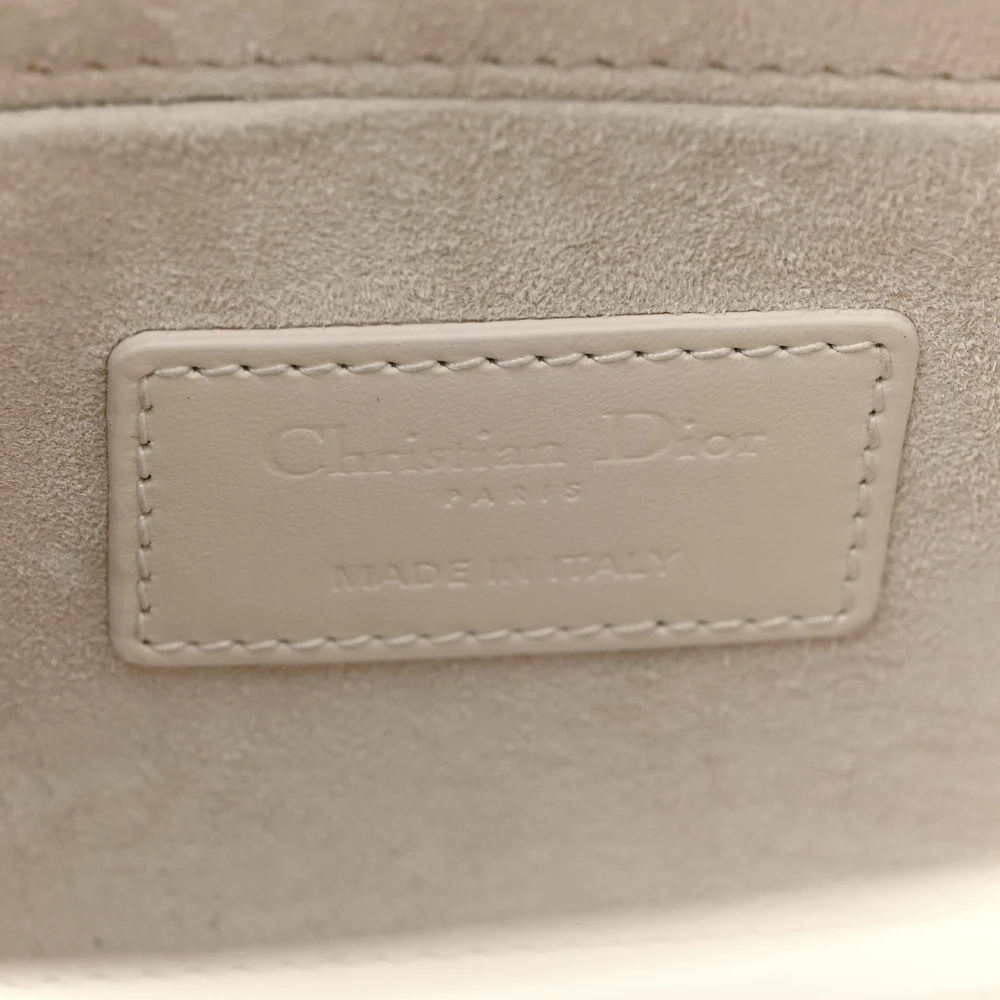 Close-up of the letter charms and gold-tone hardware on the latte Cannage Medium Lady D-Joy bag