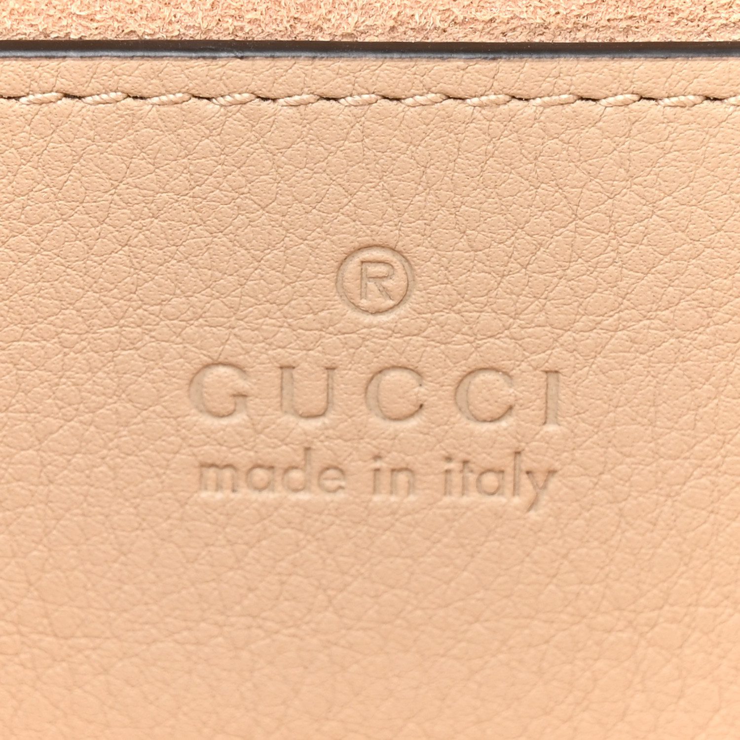 Close-up of the padlock closure, GG Supreme canvas, Web stripe, and gold-tone hardware