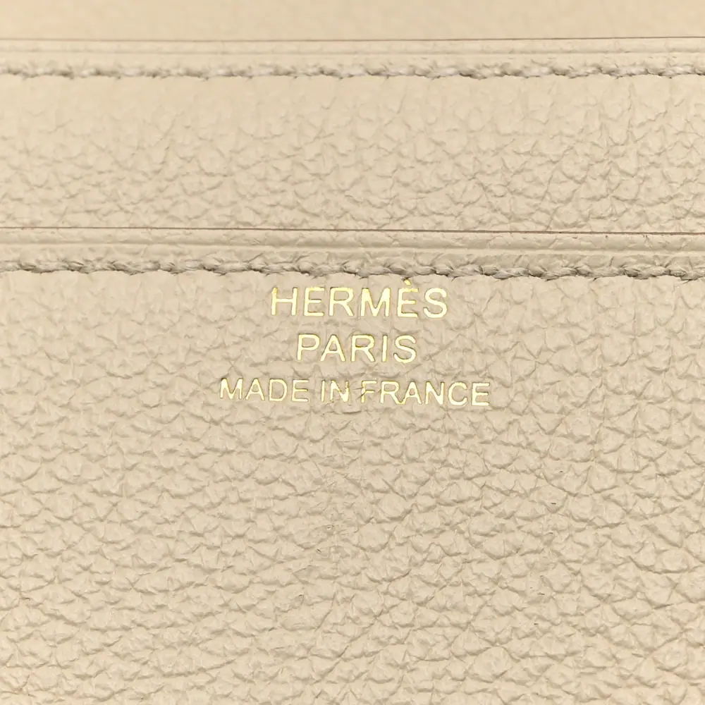 Close-up of the Hermès H clasp and gold hardware on the Evercolor Constance Wallet To Go