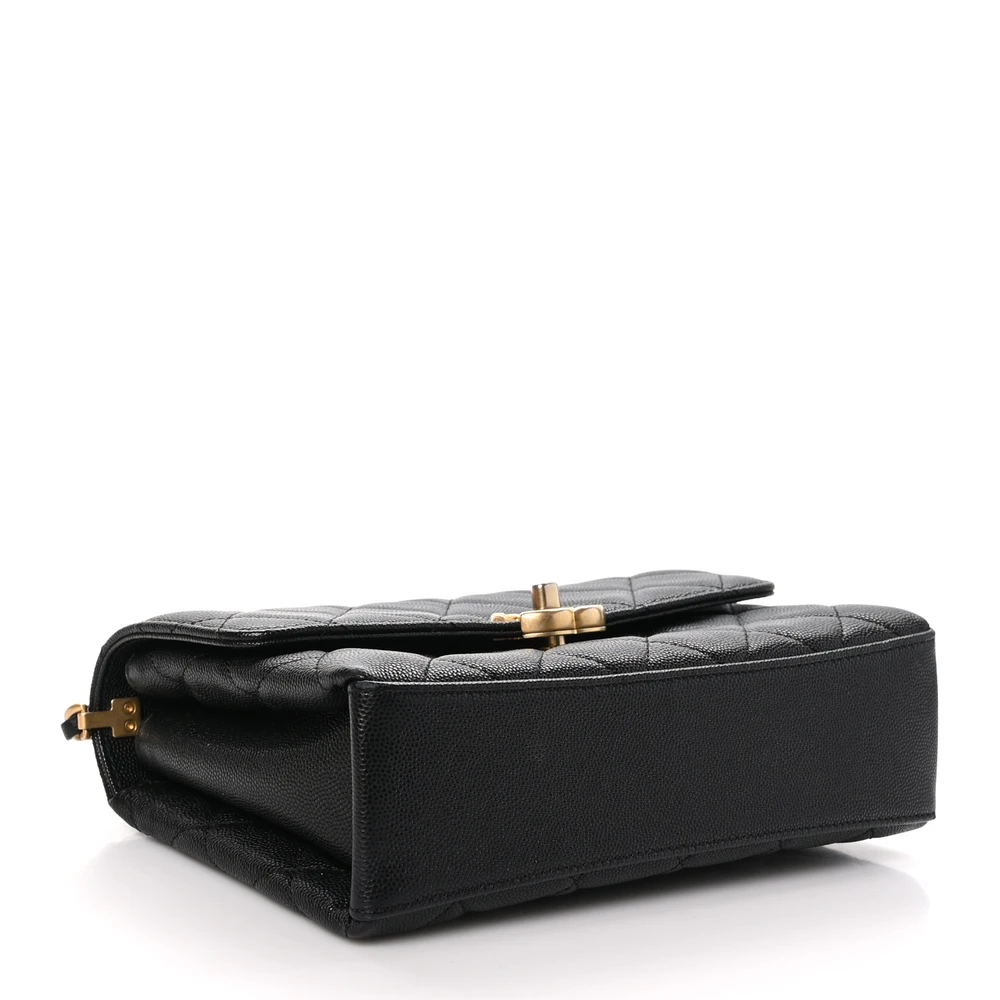 Bottom view of the black caviar leather Ch@nel Medium Carry Me Flap with elegant top handle