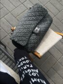 Model carrying the quilted grey and black Denimpression XXL Flap with silver chain straps