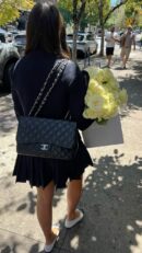Model carrying the black caviar leather Jumbo Double Flap with silver chain straps