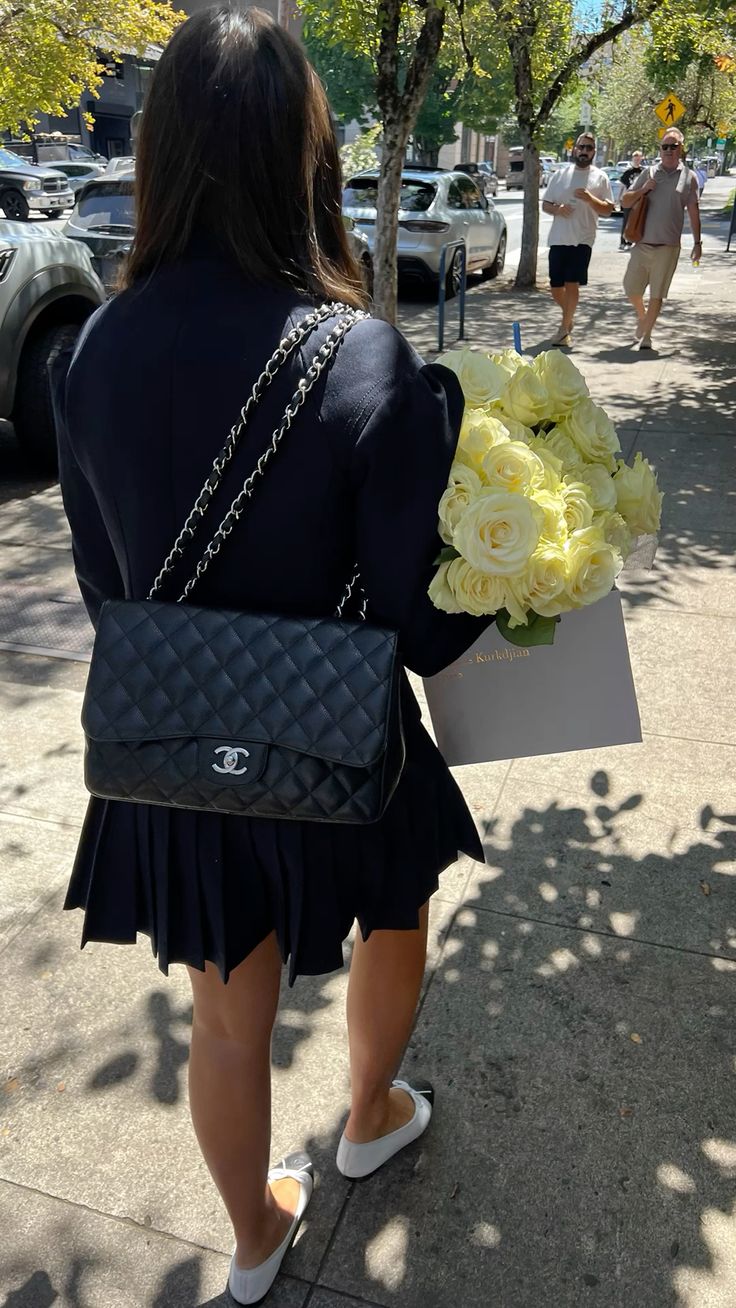 Model carrying the black caviar leather Jumbo Double Flap with silver chain straps