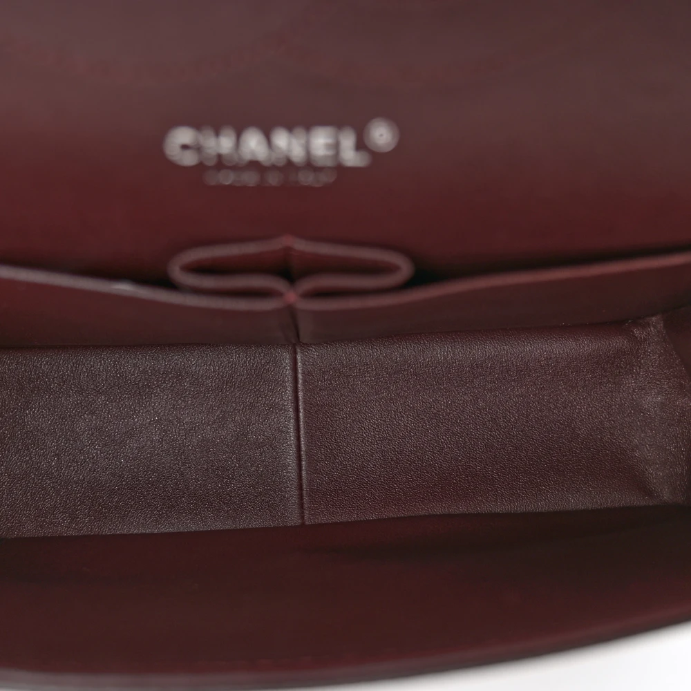 Interior view of the black caviar leather Jumbo Double Flap with organized storage compartments
