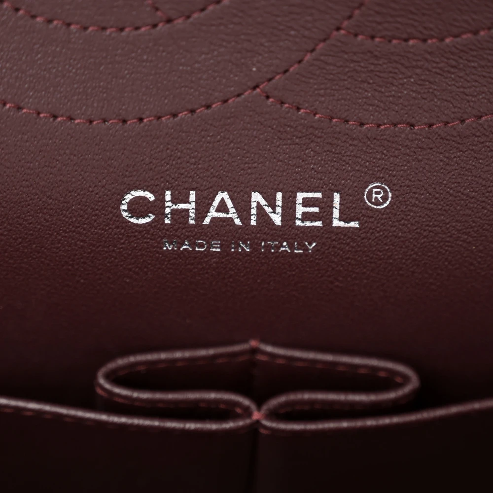 Close-up of the CC turn-lock, silver chain straps, and silver-tone hardware on the Jumbo Double Flap