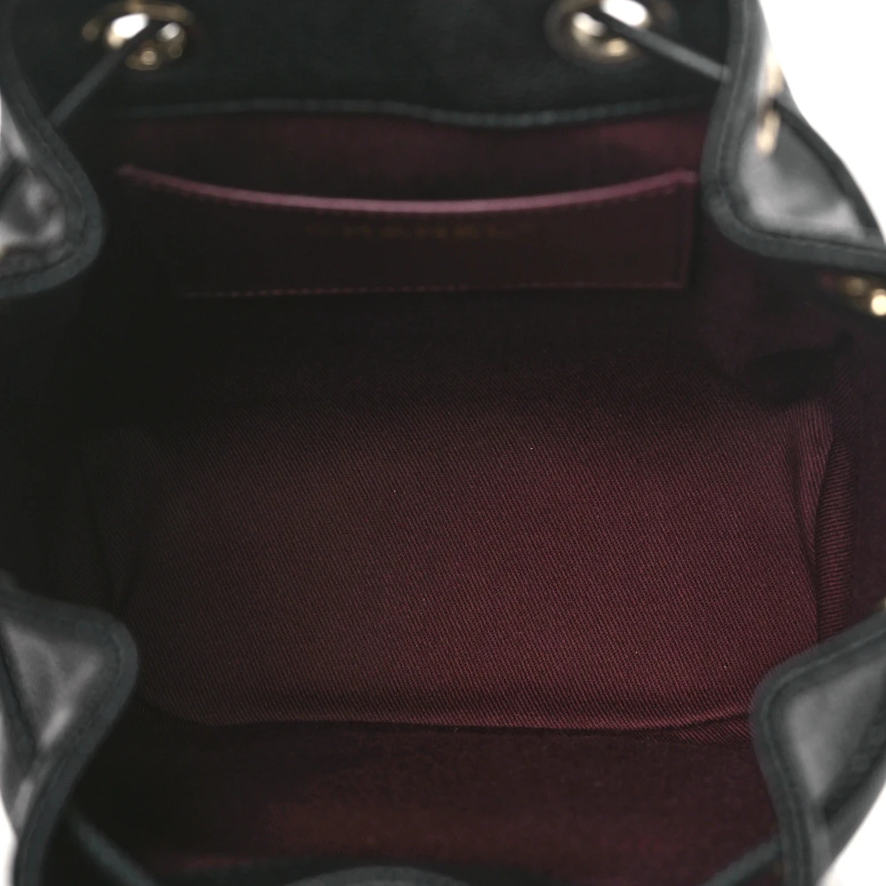 Interior view of the black caviar leather Ch@nel Mini CC Pocket Bucket Bag with spacious storage