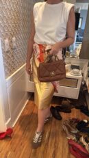Model carrying the brown quilted lambskin leather Large Ch@nel 19 Flap with mixed metal chain strap