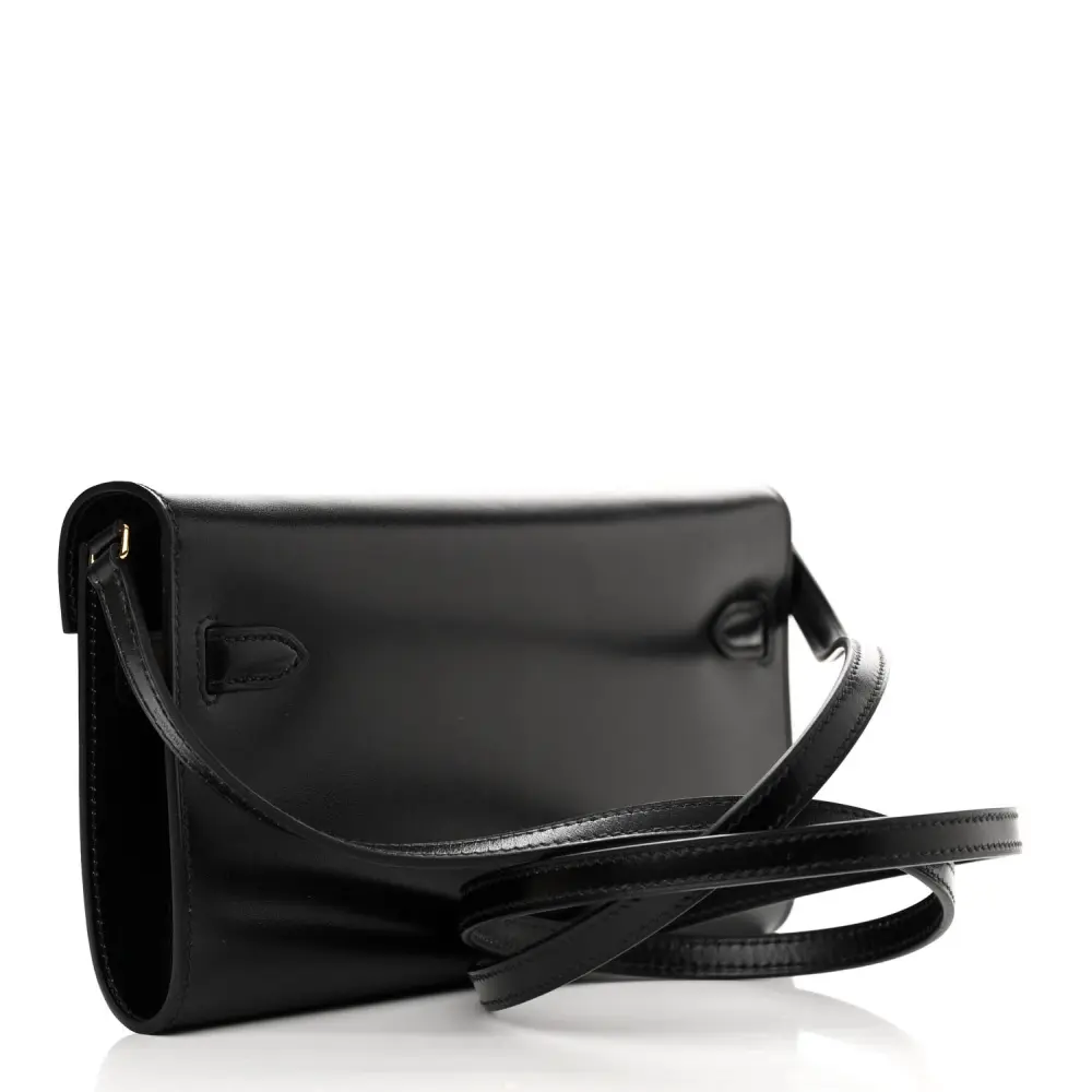 back view of the Herme$ Black Box Leather Kelly Wallet To Go with gold hardware