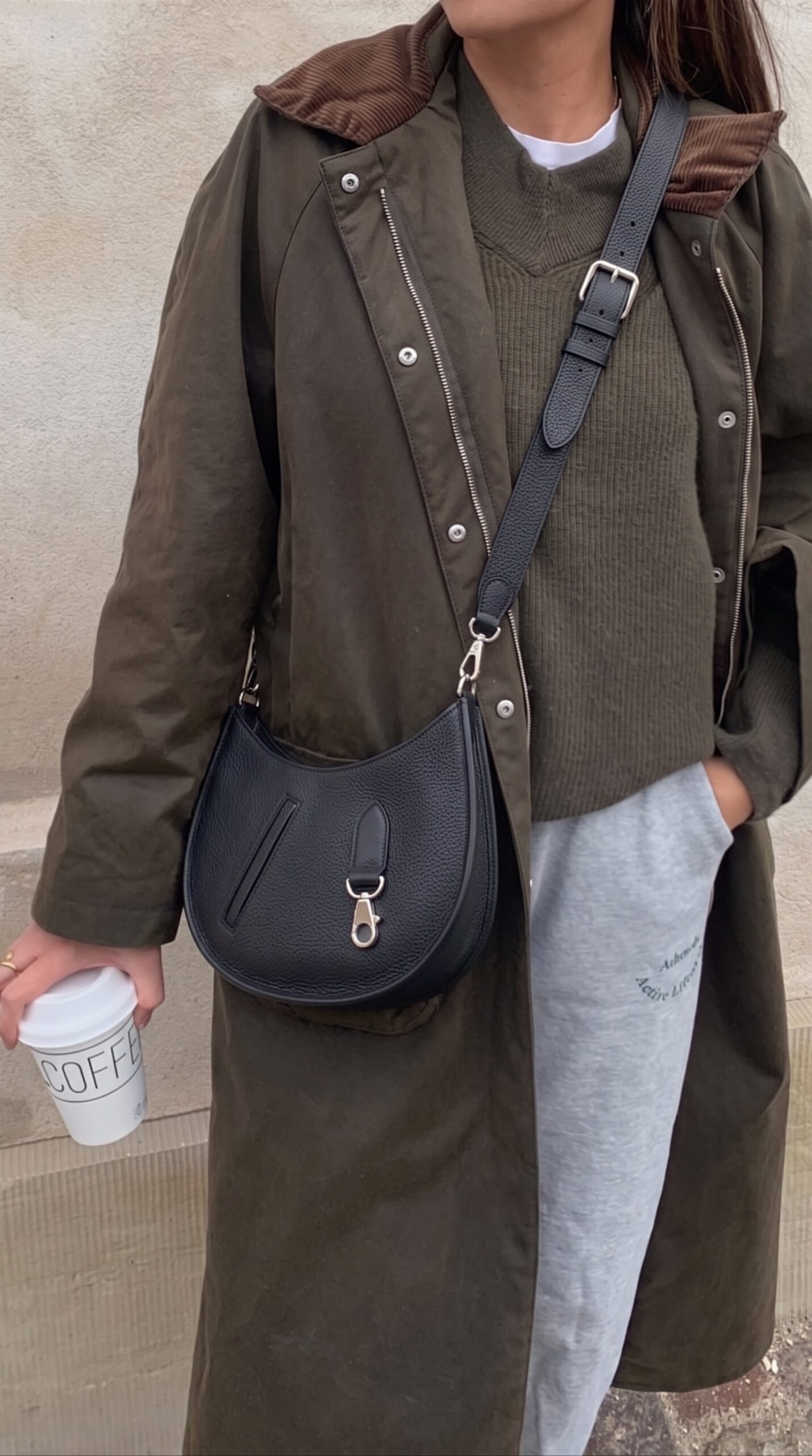 Model carrying the Herme$ Black Togo and Swift Leather P’tit Arçon