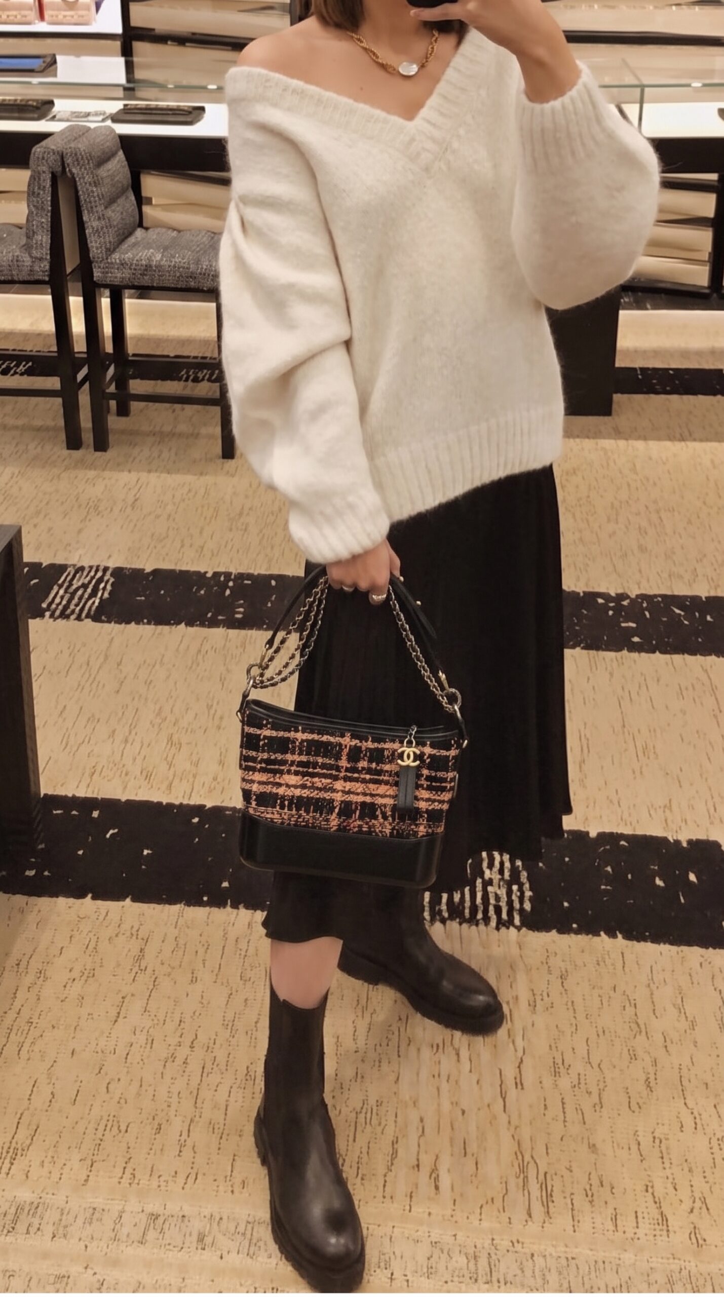 Model carrying the black and brown tweed Medium Gabrielle Hobo with gradient metal chain strap
