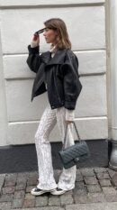 Model carrying the green iridescent caviar leather ch@nel Jumbo Double Flap with light gold chain strap
