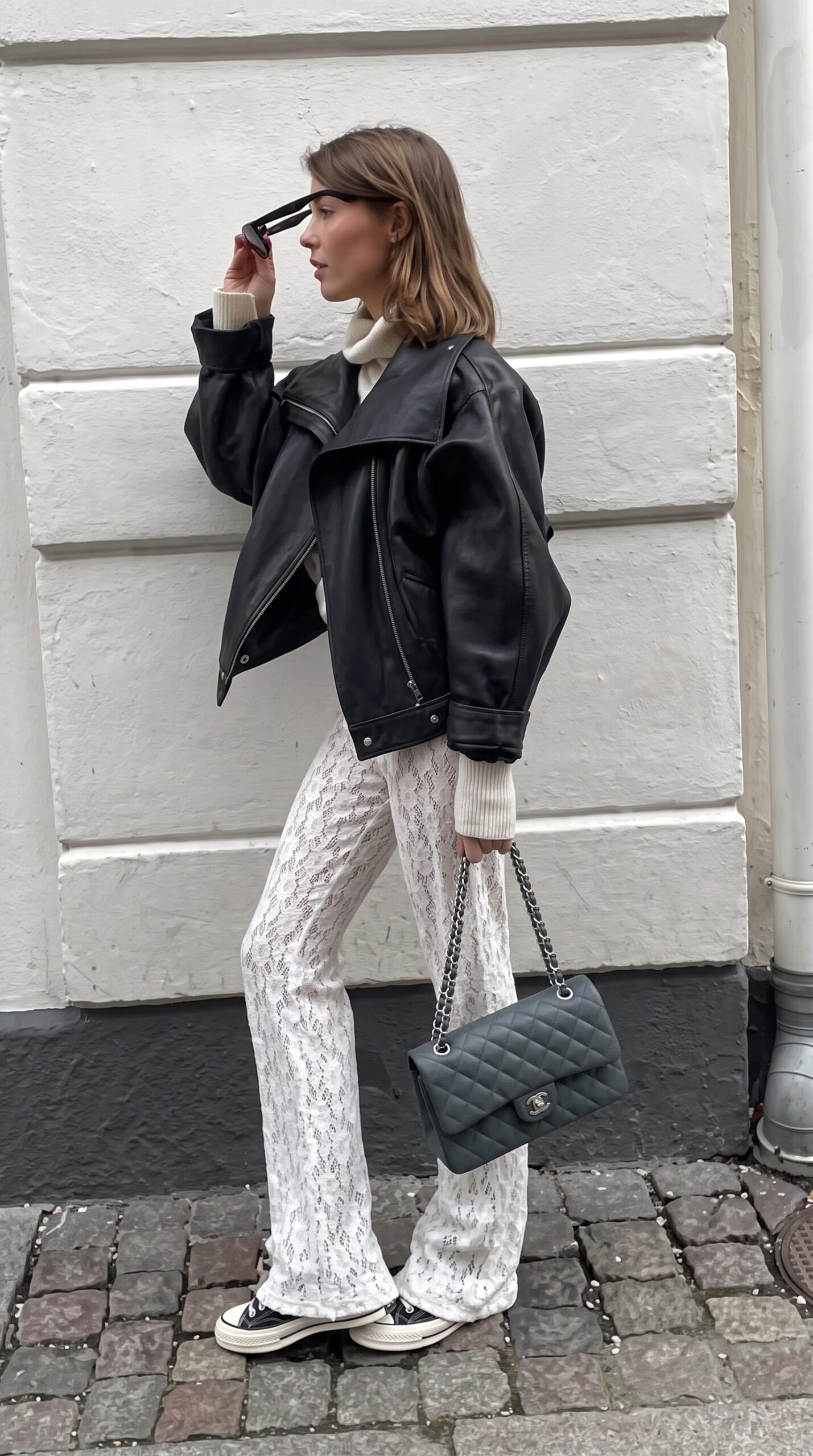 Model carrying the green iridescent caviar leather ch@nel Jumbo Double Flap with light gold chain strap