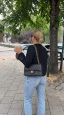 Model carrying the grey gradient lambskin Medium Double Flap with light gold chain shoulder strap