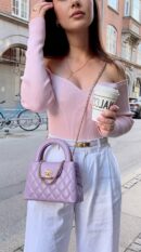 Model carrying the lilac aged calfskin Ch@nel Nano Kelly Shopper with gold chain strap