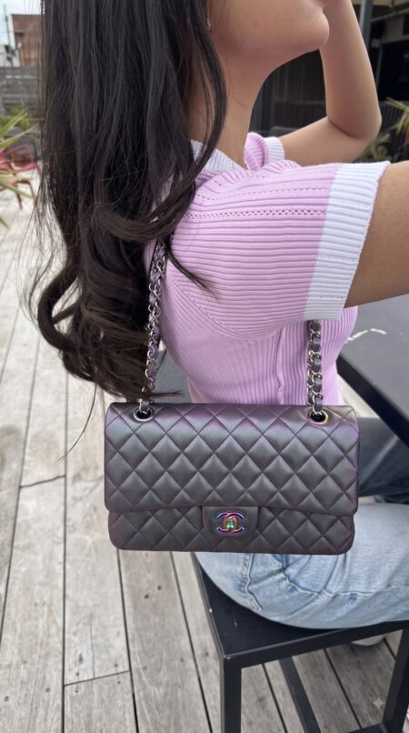 Model carrying the iridescent purple goatskin Ch@nel Medium Double Flap with chain-link straps
