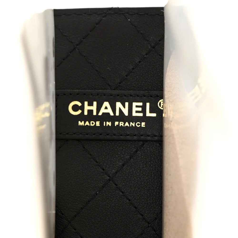 Close-up of the CC logo, faux pearl shoulder strap, and gold-tone hardware on the Ch@nel Sand By The Sea Flap