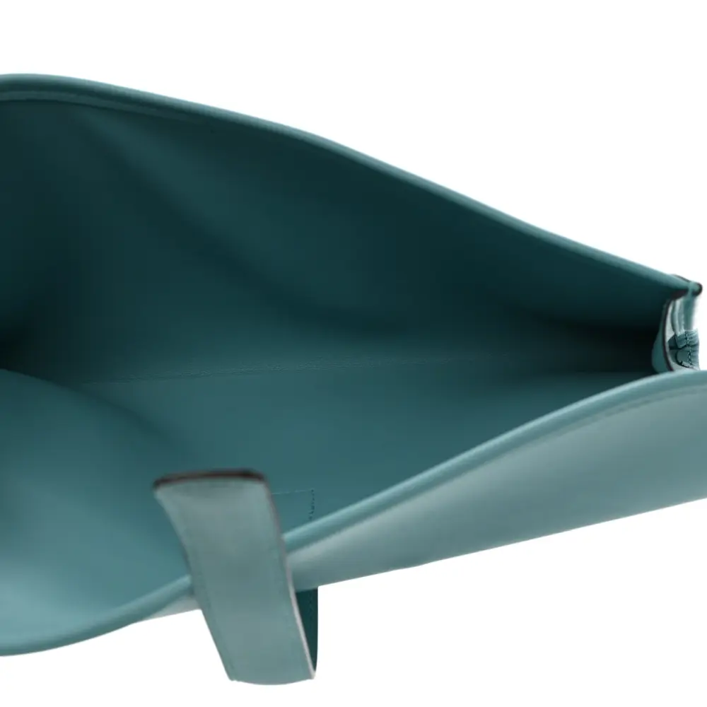 Interior view of the Herme$ Bleu Atoll Swift Leather Jige Elan 29 Clutch with smooth leather lining
