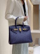 Model is carrying superclone Herme$ Birkin 40 Epsom Midnight Blue handbags