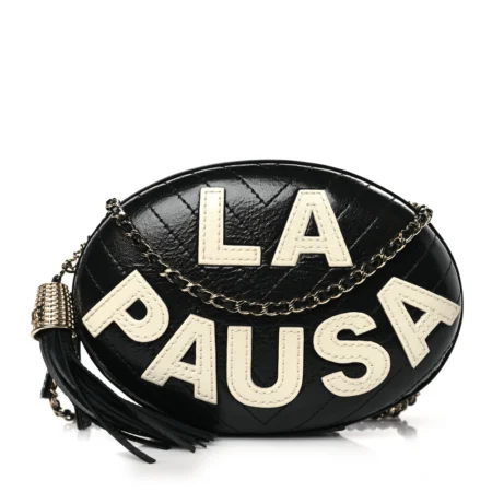 Front view of the black lambskin Ch@nel La Pausa Tassel Clutch with chevron quilting