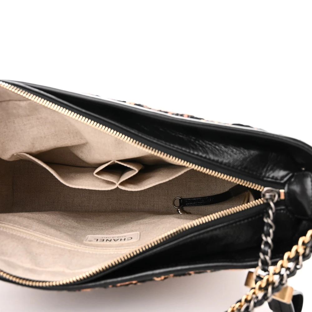 Interior view of the black and brown tweed Medium Gabrielle Hobo with organized storage compartments