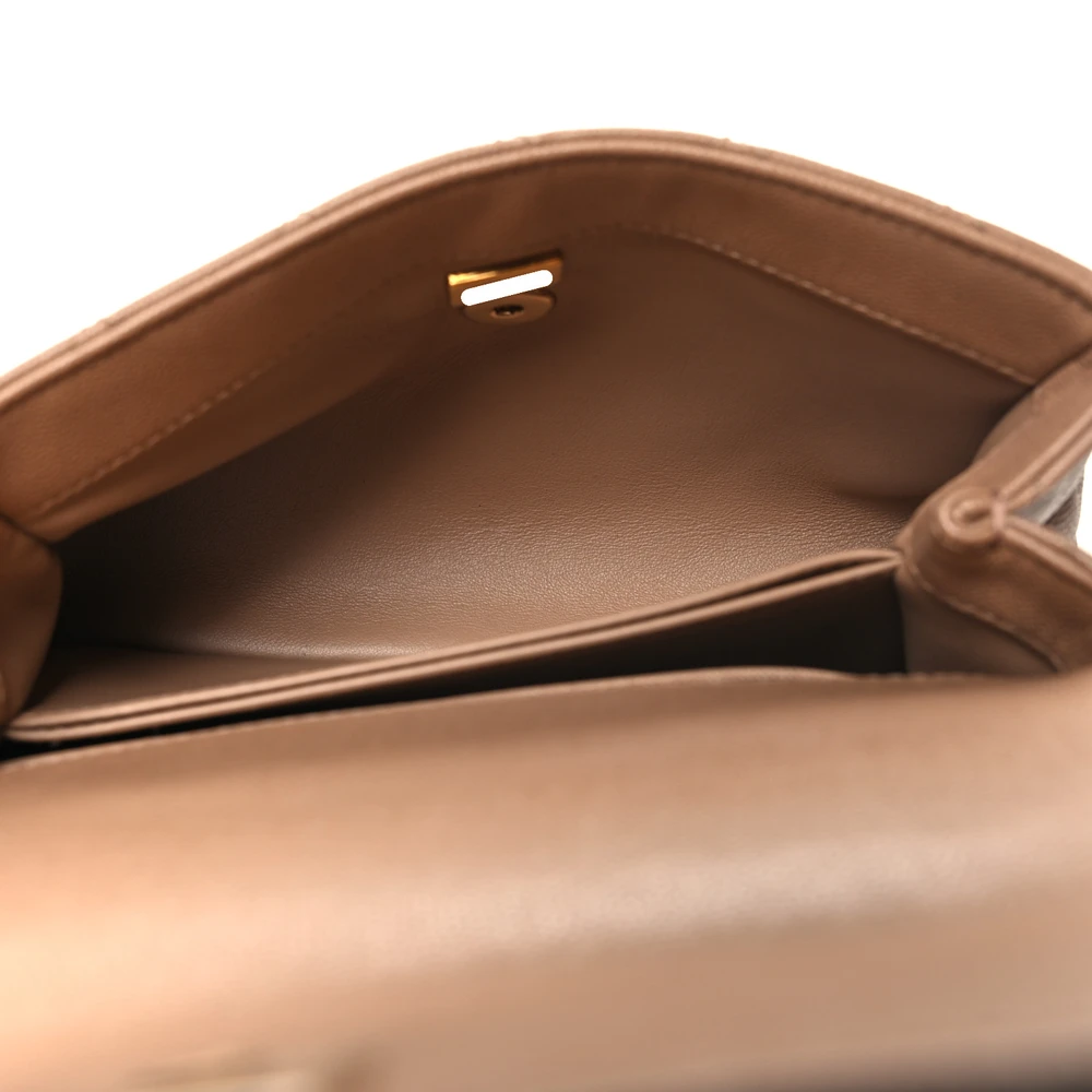 Interior view of the brown caviar leather Mini Coco Handle Flap with organized storage