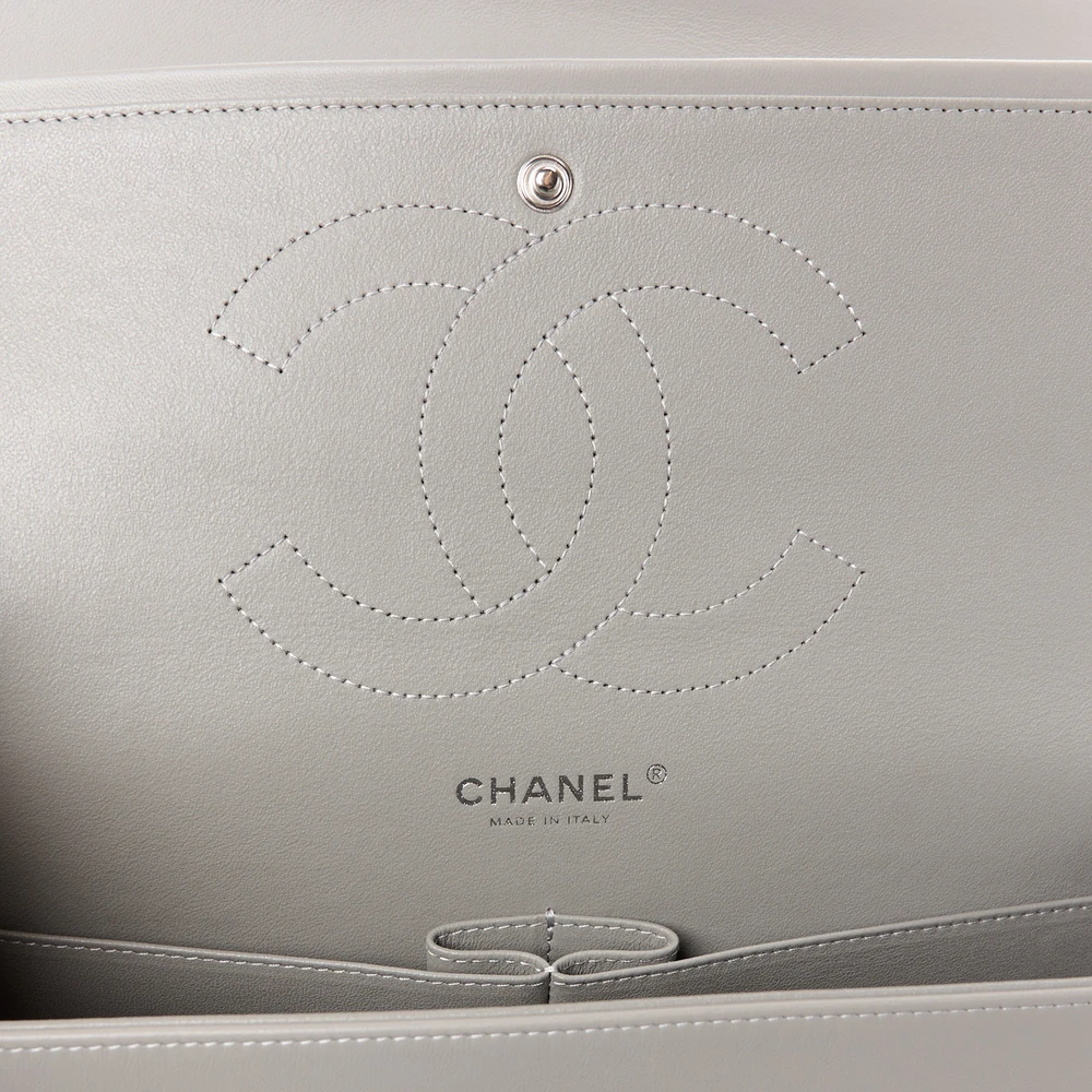 Close-up of the CC turn-lock, gold chain straps, and gold-tone hardware on the Jumbo Double Flap