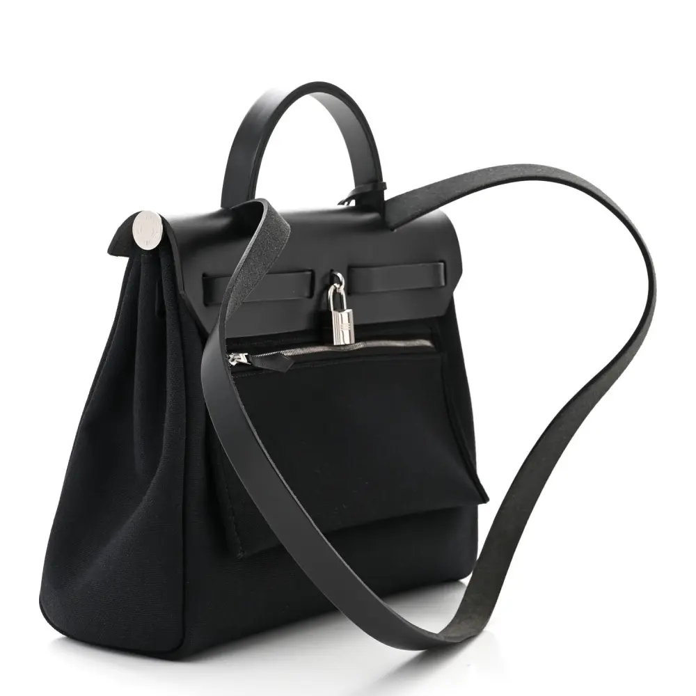 Back view of the Herme$ Military Toile Vache Hunter Herbag Zip PM 31 in Black