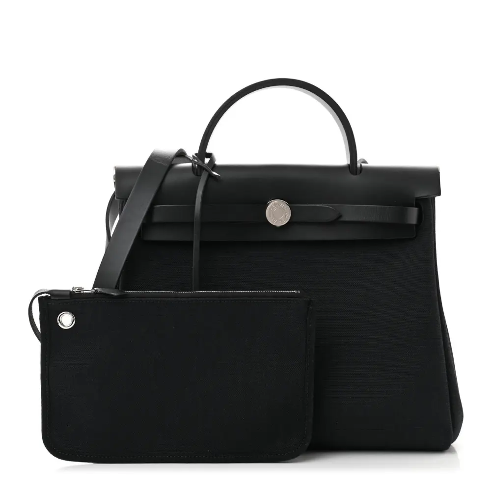 Front view of the Herme$ Military Toile Vache Hunter Herbag Zip PM 31 in Black