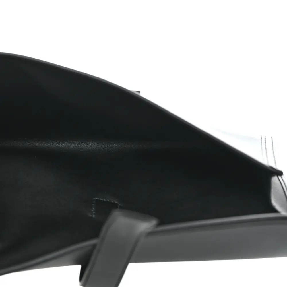 Interior view of the Herme$ Black Swift Leather Jige Elan 29 Clutch with smooth leather lining