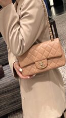 Model carrying the brown lambskin Mini Rectangular Flap with light gold chain strap