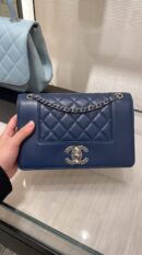 Model carrying the dark navy sheepskin Vintage Mademoiselle Flap with chain shoulder strap