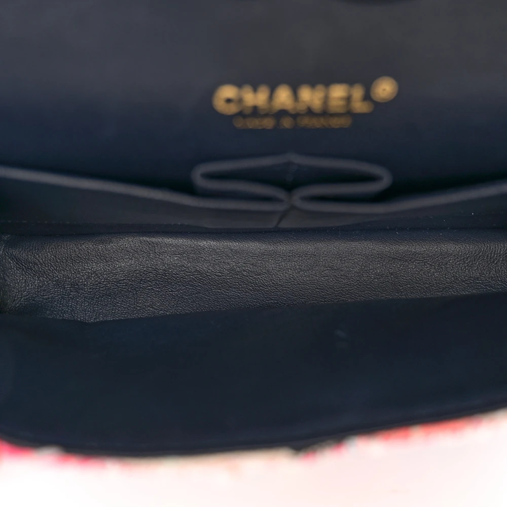 Close-up of the CC turn-lock, light gold chain strap, and light gold-tone hardware on the Medium Double Flap