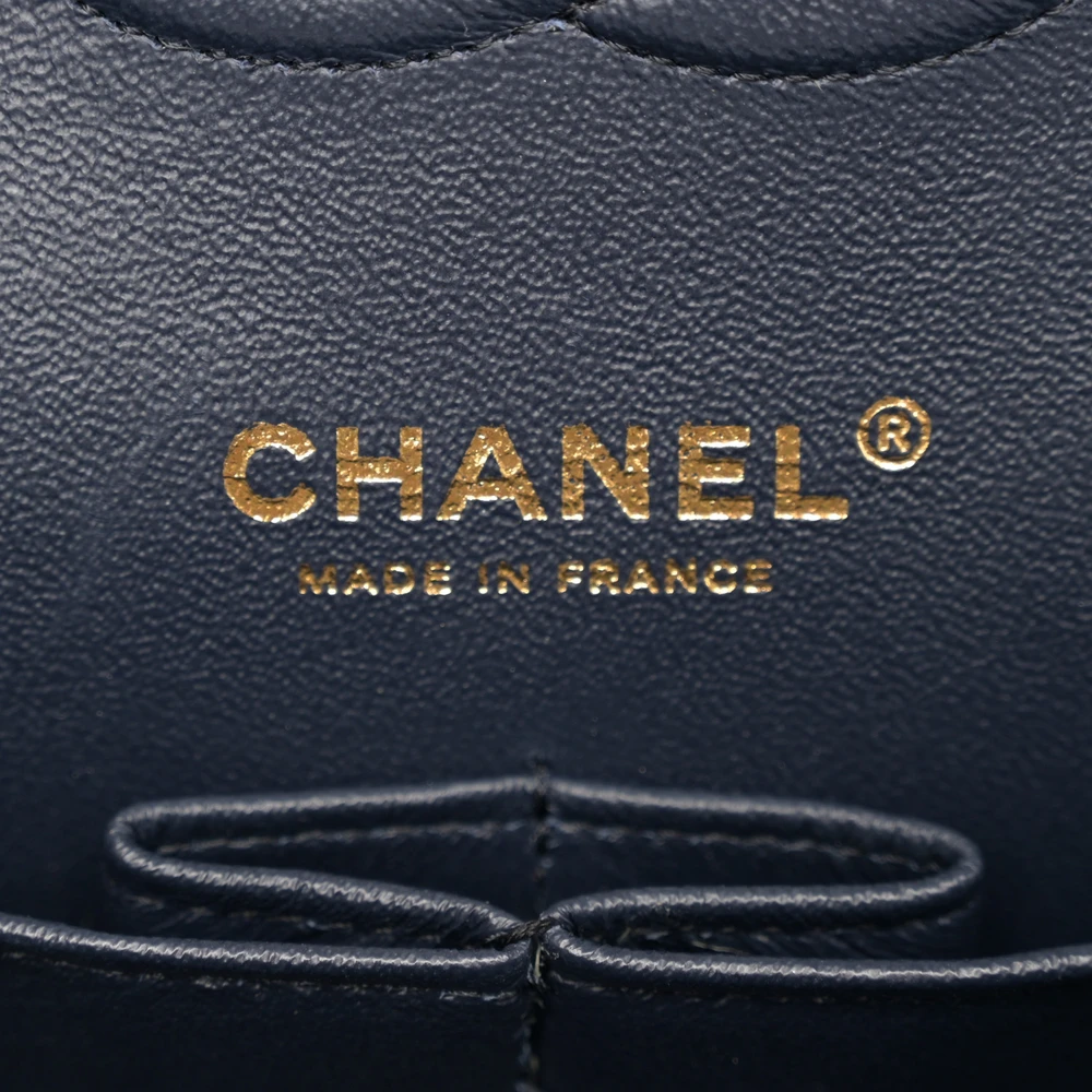 Close-up of the CC turn-lock, light gold chain strap, and light gold-tone hardware on the Medium Double Flap