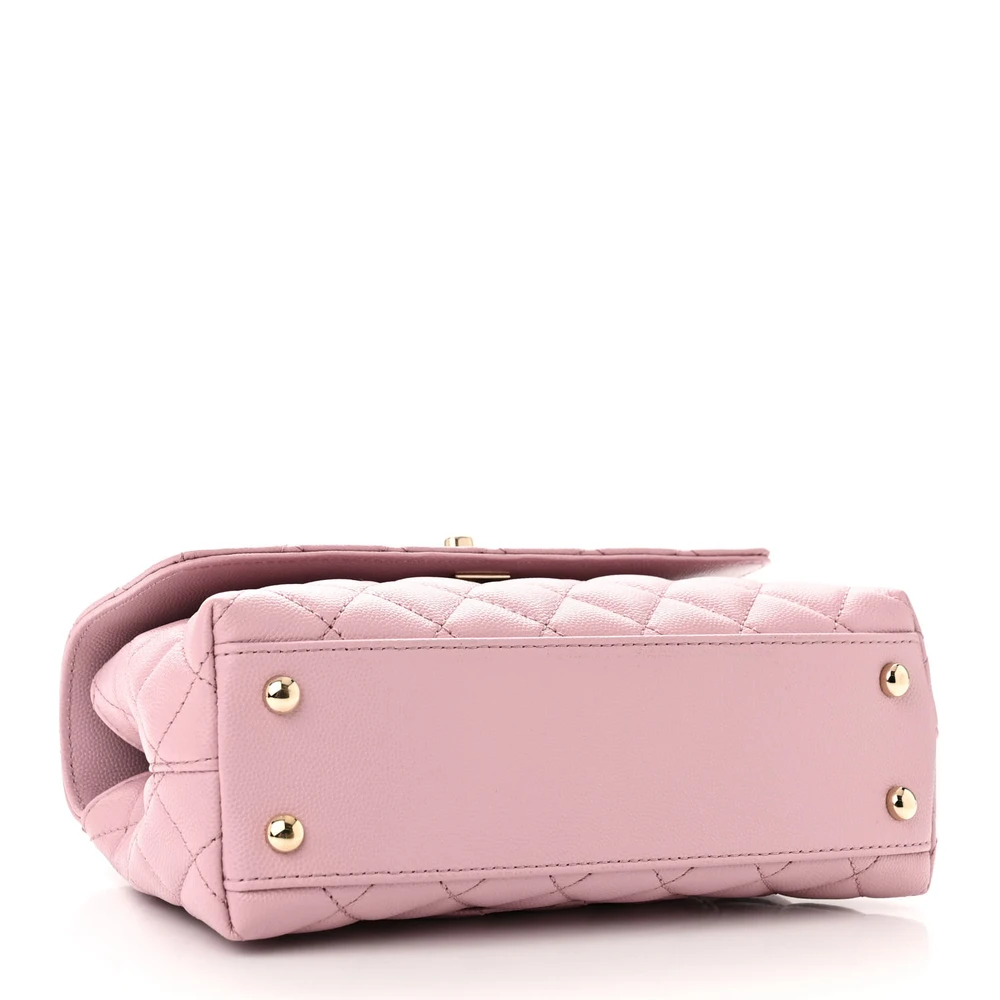 Bottom view of the light pink caviar leather Mini Coco Handle Flap with gold chain strap
