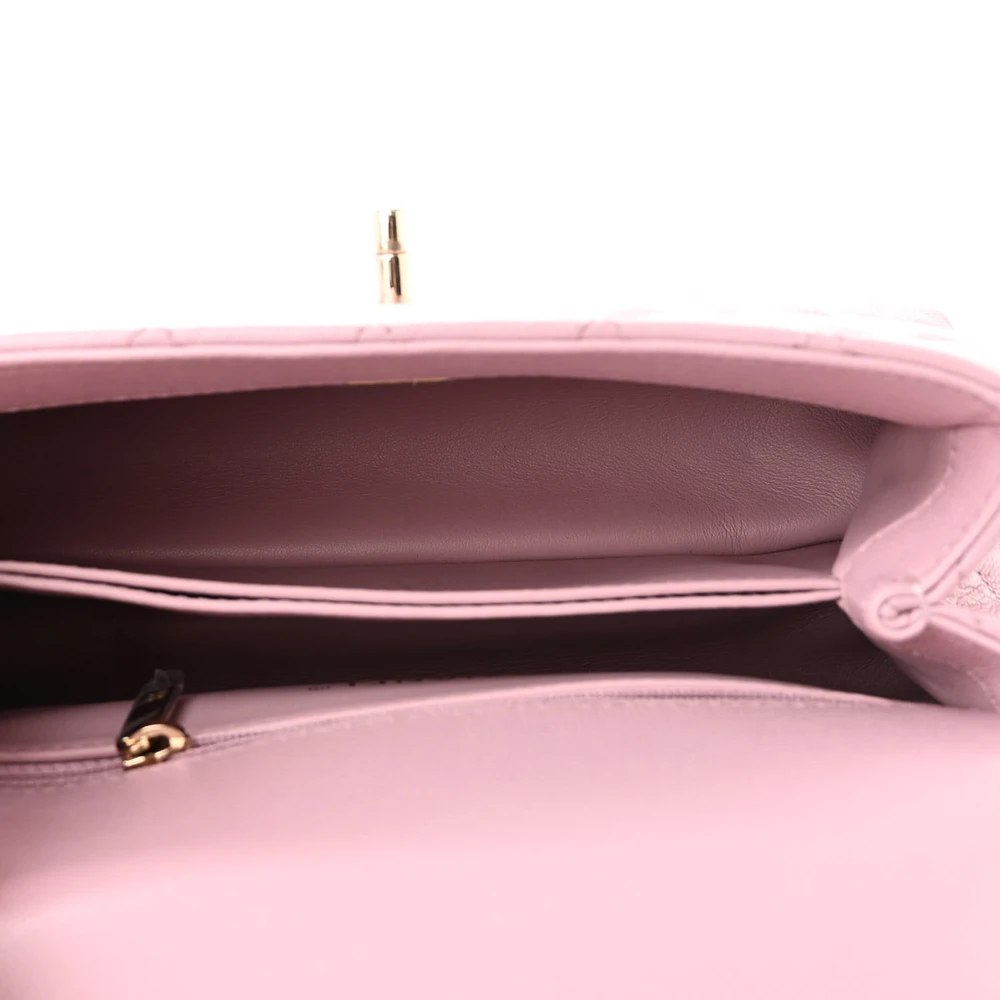 Interior view of the light pink caviar leather Mini Coco Handle Flap with organized storage