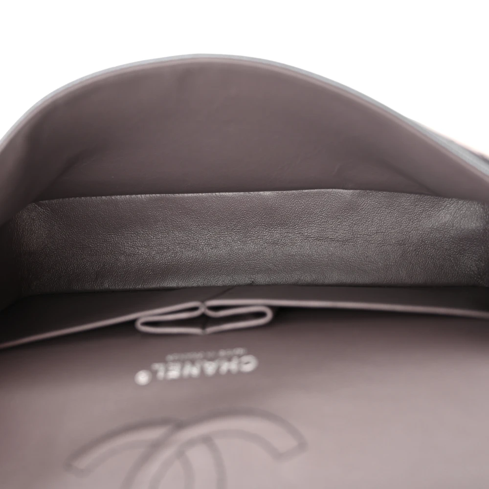 Interior view of the iridescent purple goatskin Ch@nel Medium Double Flap with organised storage compartments