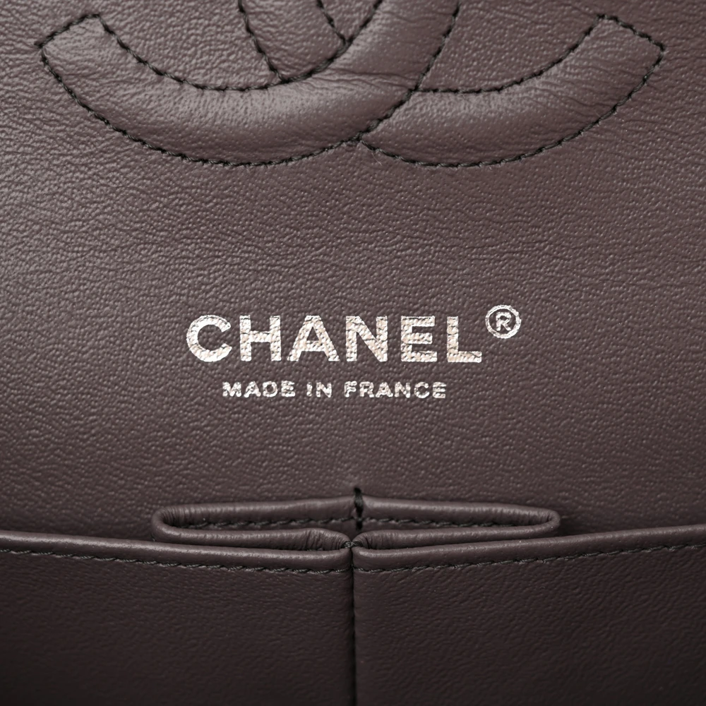 Close-up of the ruthenium CC turn-lock and leather-threaded iridescent chain-link straps on the Medium Double Flap