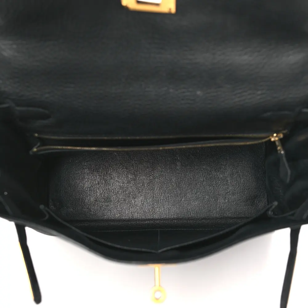 Interior view of the Herme$ Black Togo Leather Kelly Retourne 28 with leather lining, zip pocket, and slip pocket