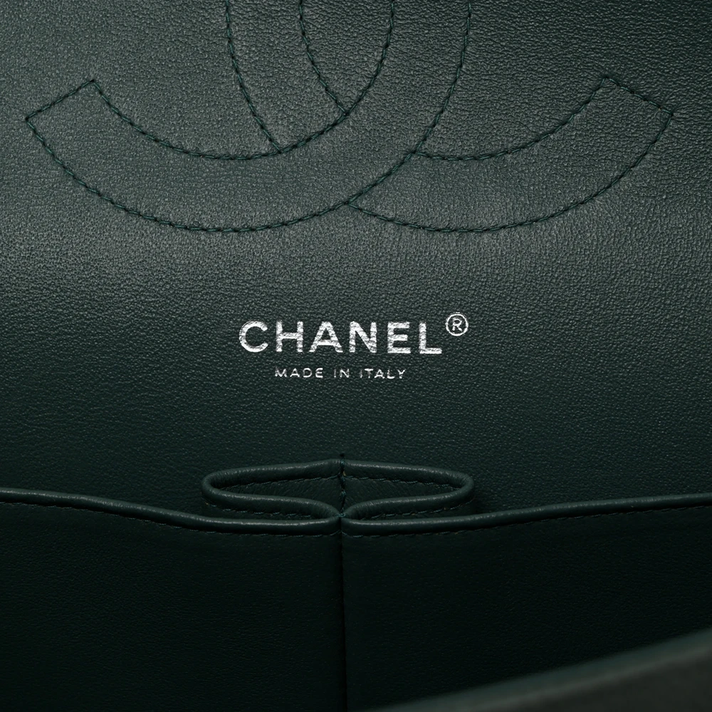 Close-up of the CC turn-lock, light gold chain strap, and light gold-tone hardware on the Jumbo Double Flap