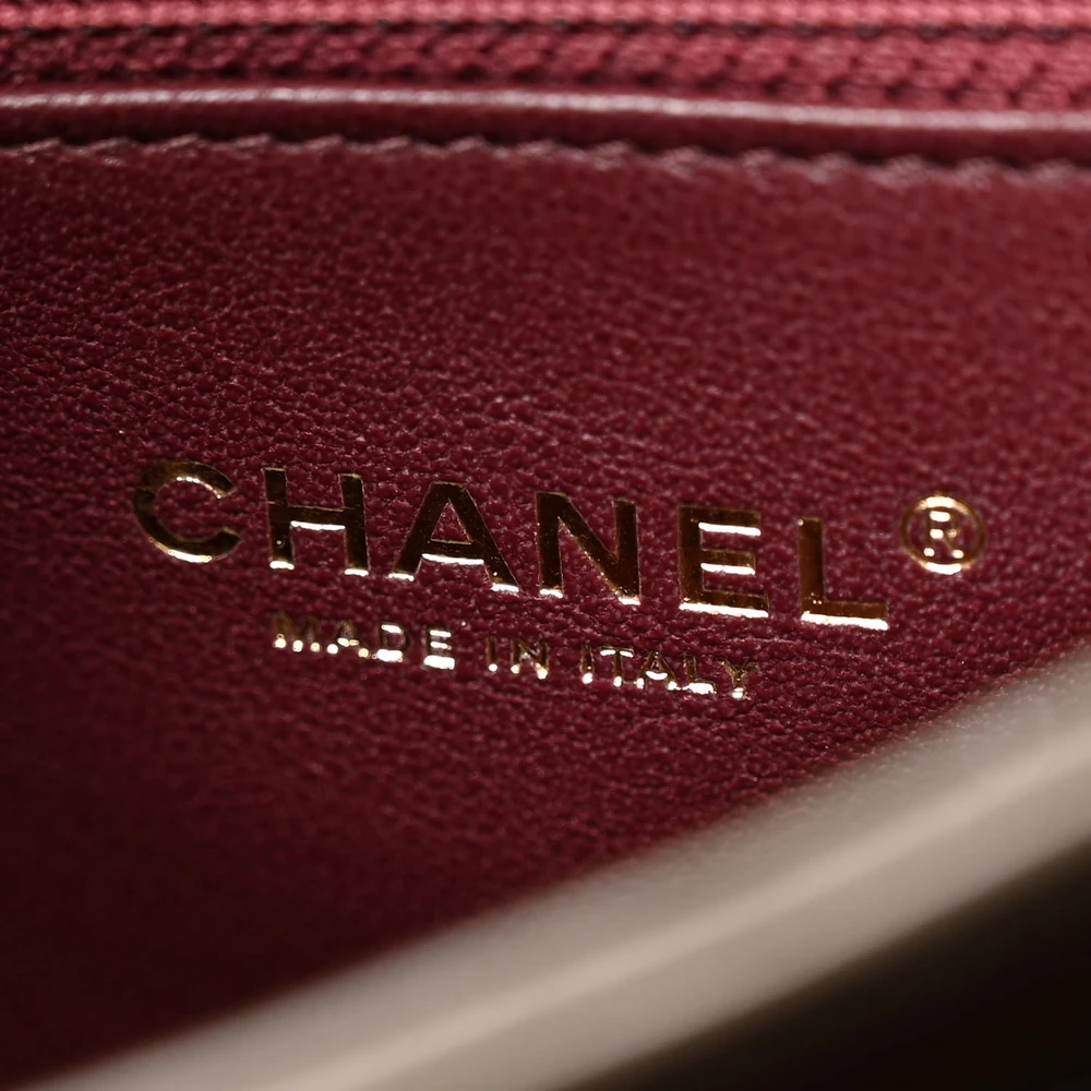 Close-up of the CC turn lock, CH@NEL top metal plate, and gold-tone hardware on the Small Trendy CC Dual Handle Flap