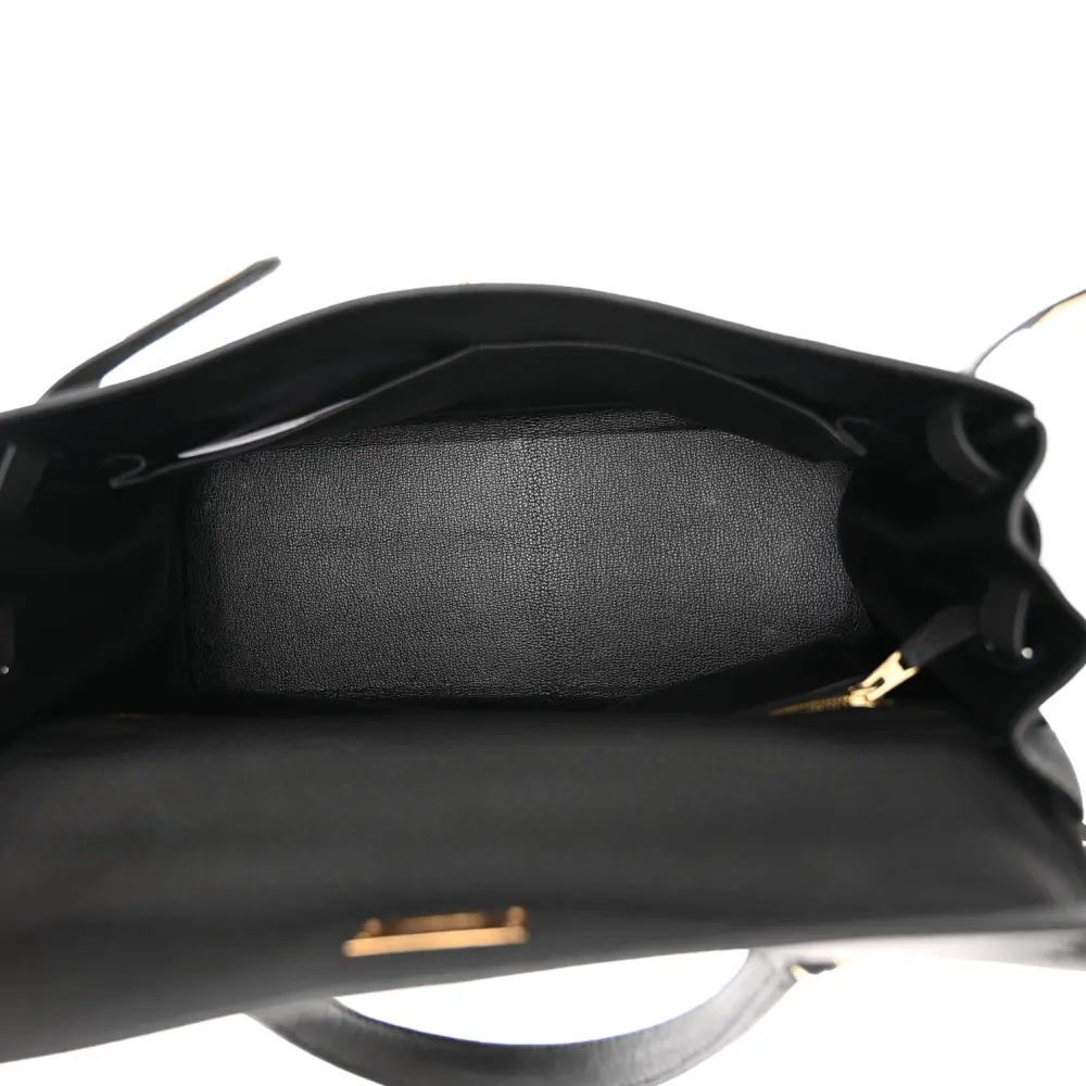 Interior view of the Herme$ Black Togo Leather Kelly Retourne 32 with leather lining, zip pocket, and slip pocket