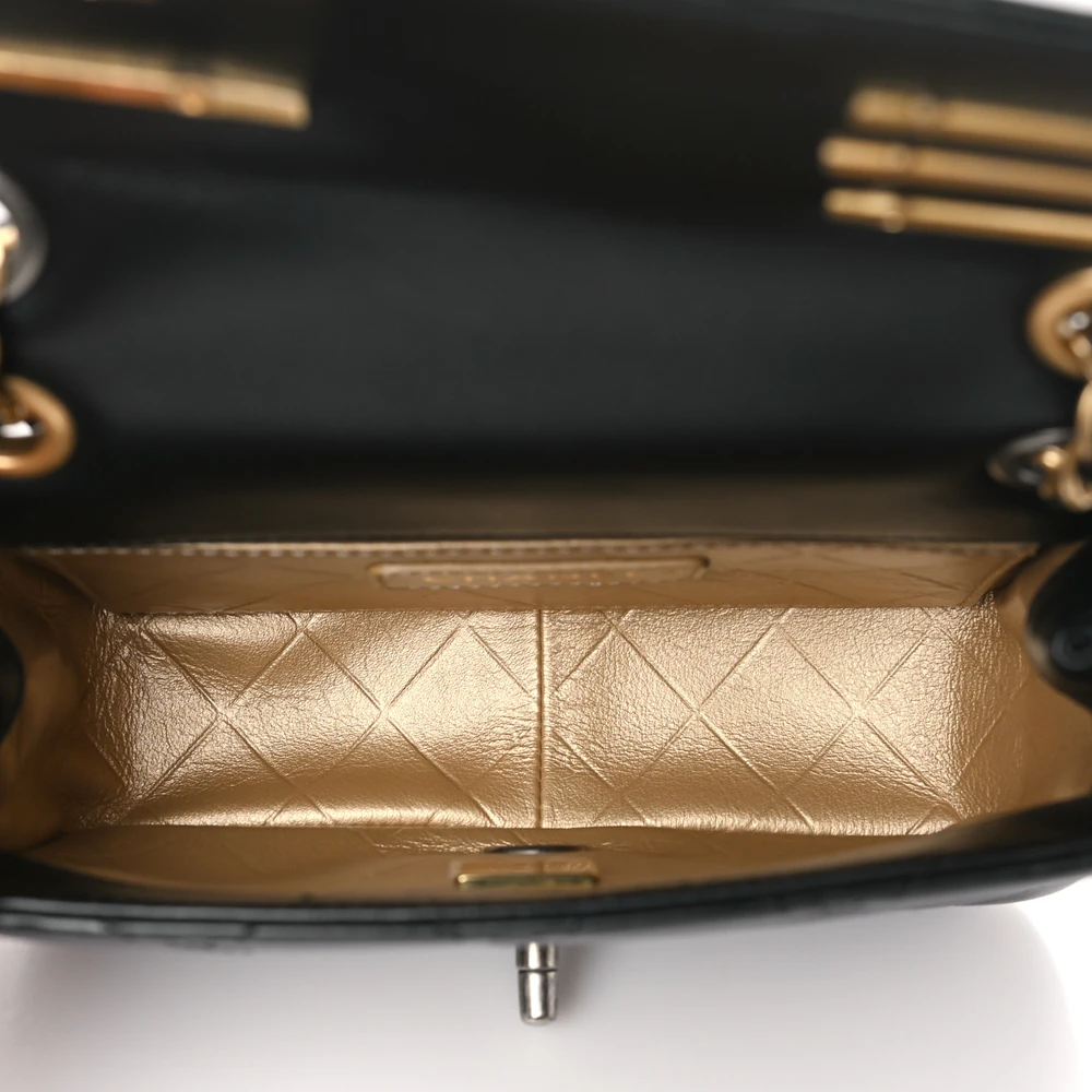Interior view of the black lambskin Ch@nel Mini Coco Clips Flap with compact storage