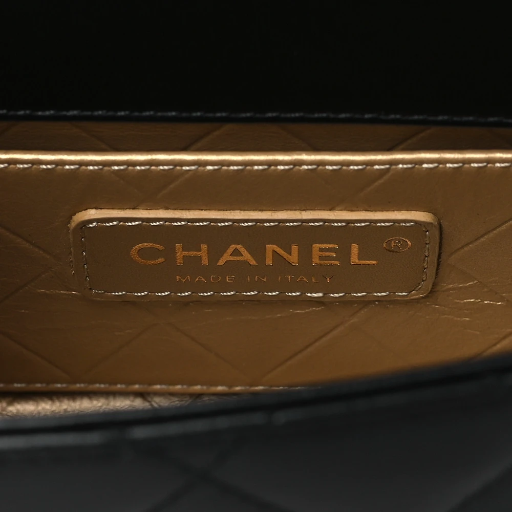 Close-up of the CC turn-lock, decorative metal clips, and two-toned chain straps on the Mini Coco Clips Flap