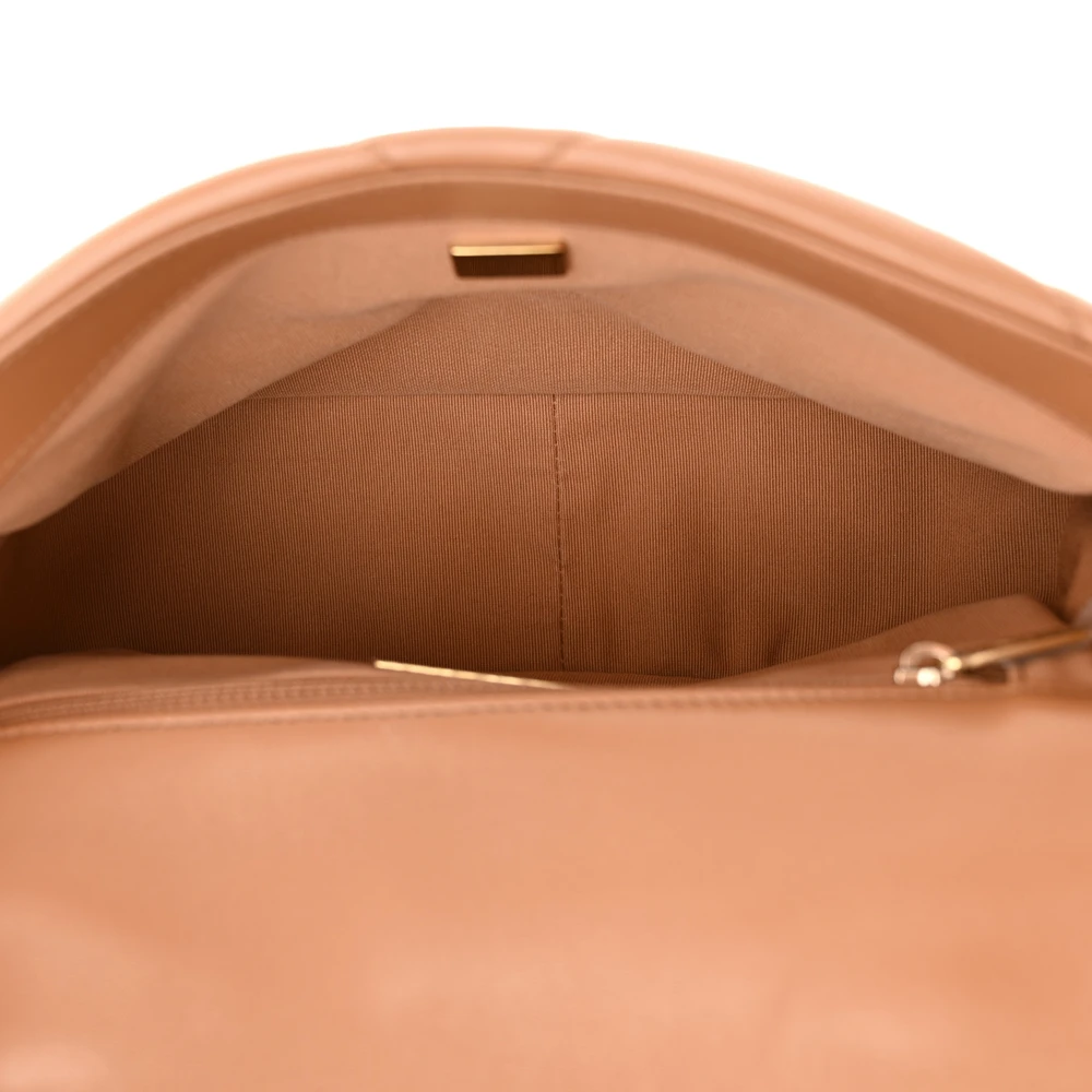 Interior view of the brown lambskin Ch@nel Medium 19 Flap with organized storage compartments