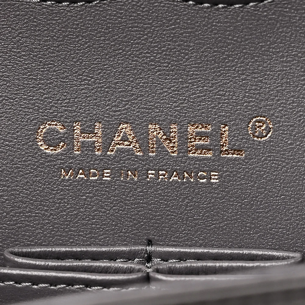 Close-up of the CC turn-lock, light gold chain strap, and light gold-tone hardware on the Medium Double Flap