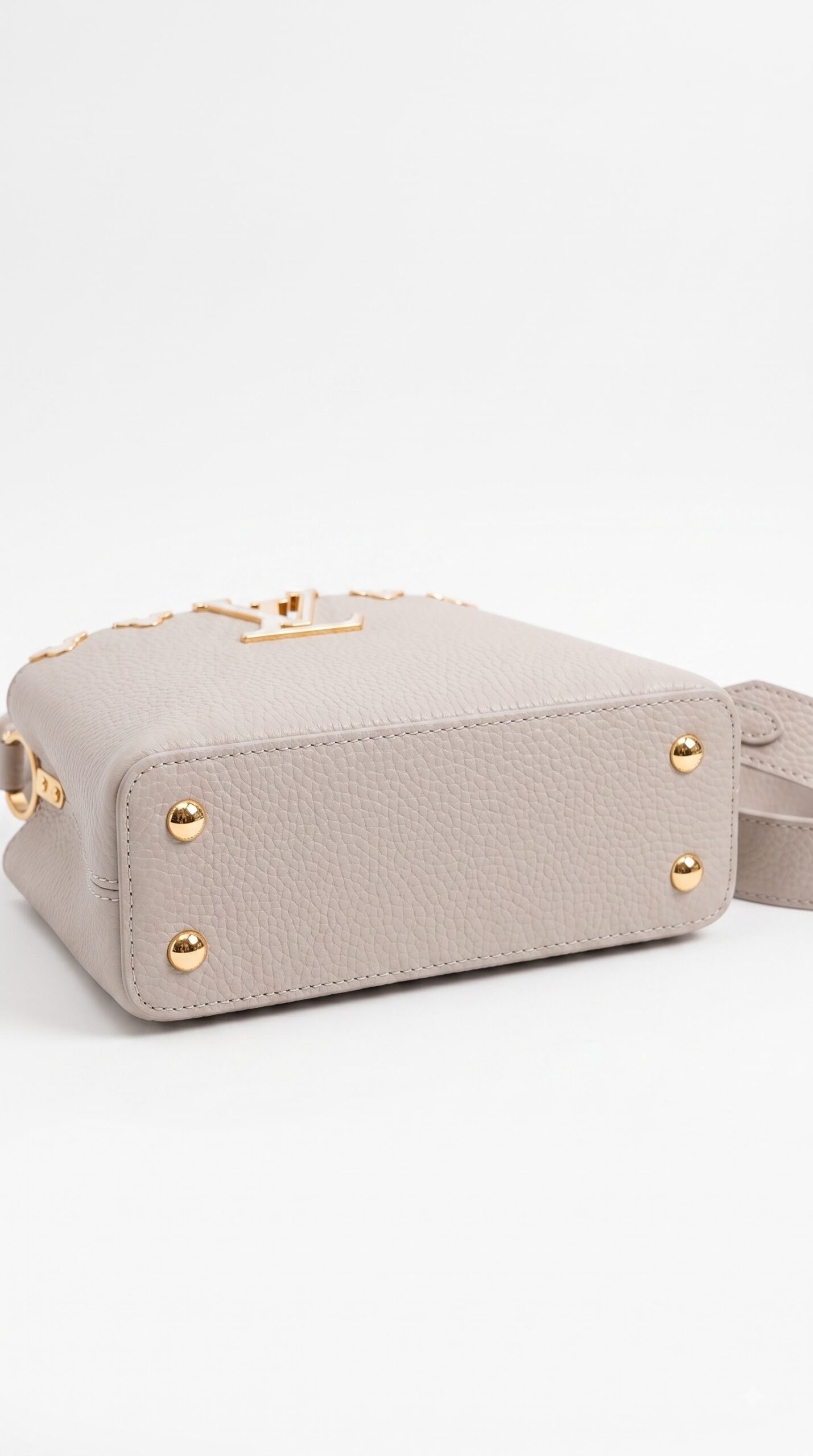 Bottom view of the Galet taupe Lou!S Vuiton Capucines Mini with floral top flap and gold-tone hardware