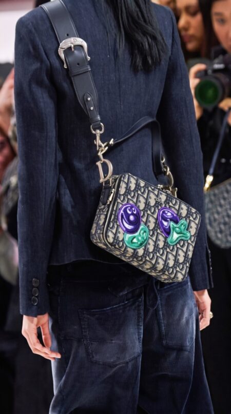 Model wearing the charcoal D!0r x Kenny Scharf Crossbody Bag over the shoulder