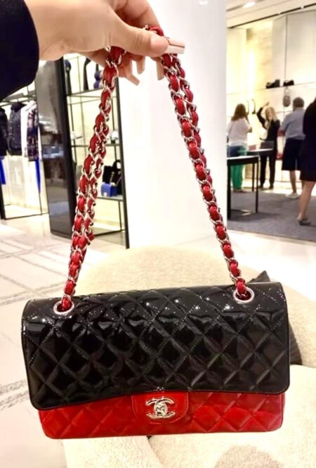 Model carrying the red and black Ch@nel Mini Rectangular Flap with silver-tone chain strap